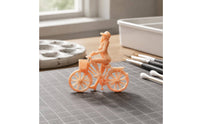 Peach Plastic Girl Bike Figurine Spoked Wheels Girl on Cycle Figure
